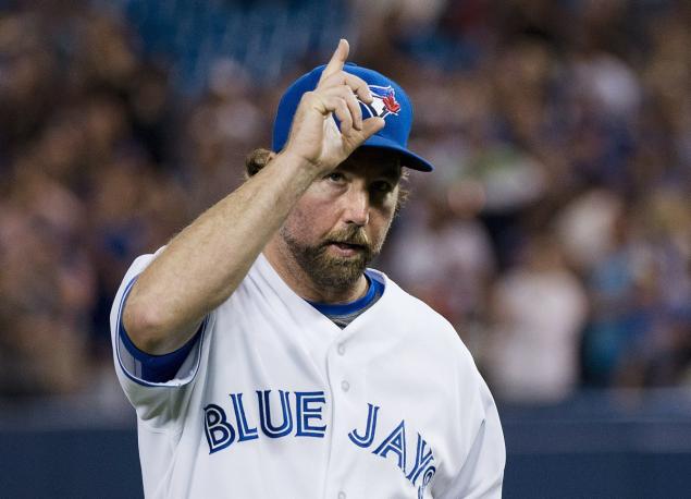 RHP R.A. Dickey tips his cap to Blue Jays fans when he makes his exit after his strong outing against the New York Mets -- two days after the death of his father.