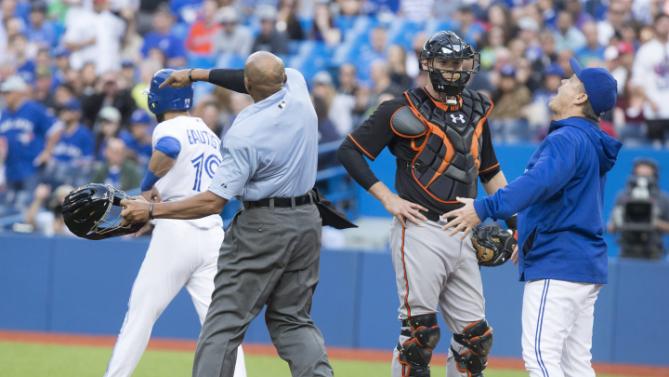 Plate ump C.B. Bucknor tosses Blue Jays manager John Gibbons after he argued when warnings were issued Friday after Mike Wright hit Jose Bautista with a pitch. 