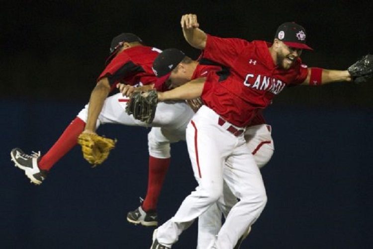 Canada's outfield of CF Tyson Gillies, LF Tyler O'Neill and RF Rene Tosoni celebrate after a win over the Dominican Republic. Photo: Fred Thornhill.