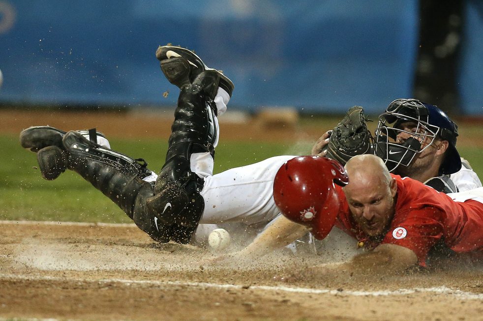Peter Orr (Newmarket, Ont.) arrives in a cloud of dust -- with the winning run in the bottom of the 10th as Canada edged Team USA 7-6 in the Pan Am gold medal game. 