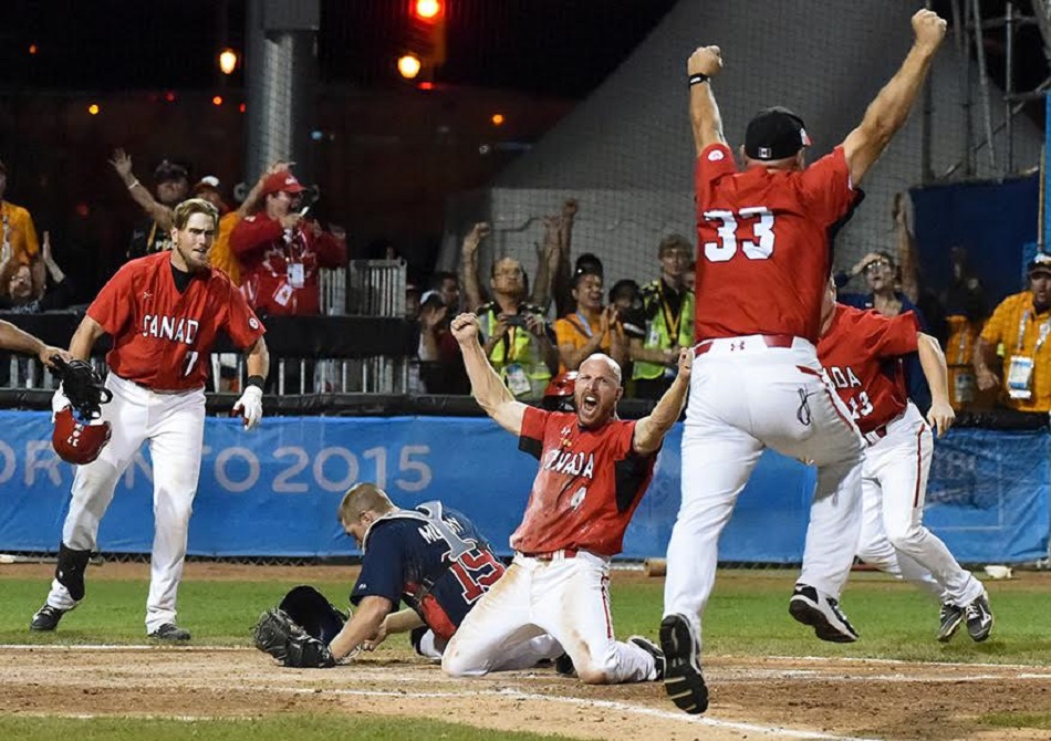 The moment was golden: Peter Orr slides home with the game winner in extras against Team USA as 1B coach Larry Walker throws his arms into the air. Photo: Joseph Howarth. For more.