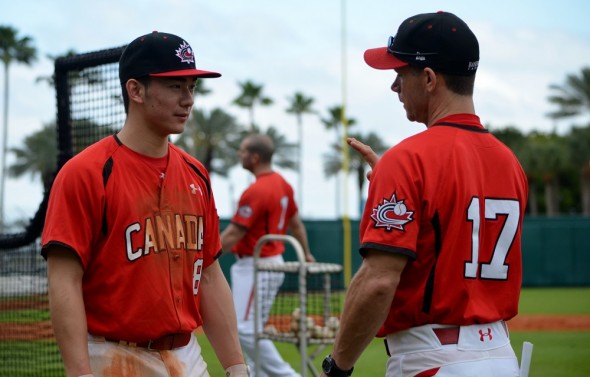 2B Royce Ando (Mississauga, Ont.) talks with Canada`s U18 coach Greg Hamilton. 