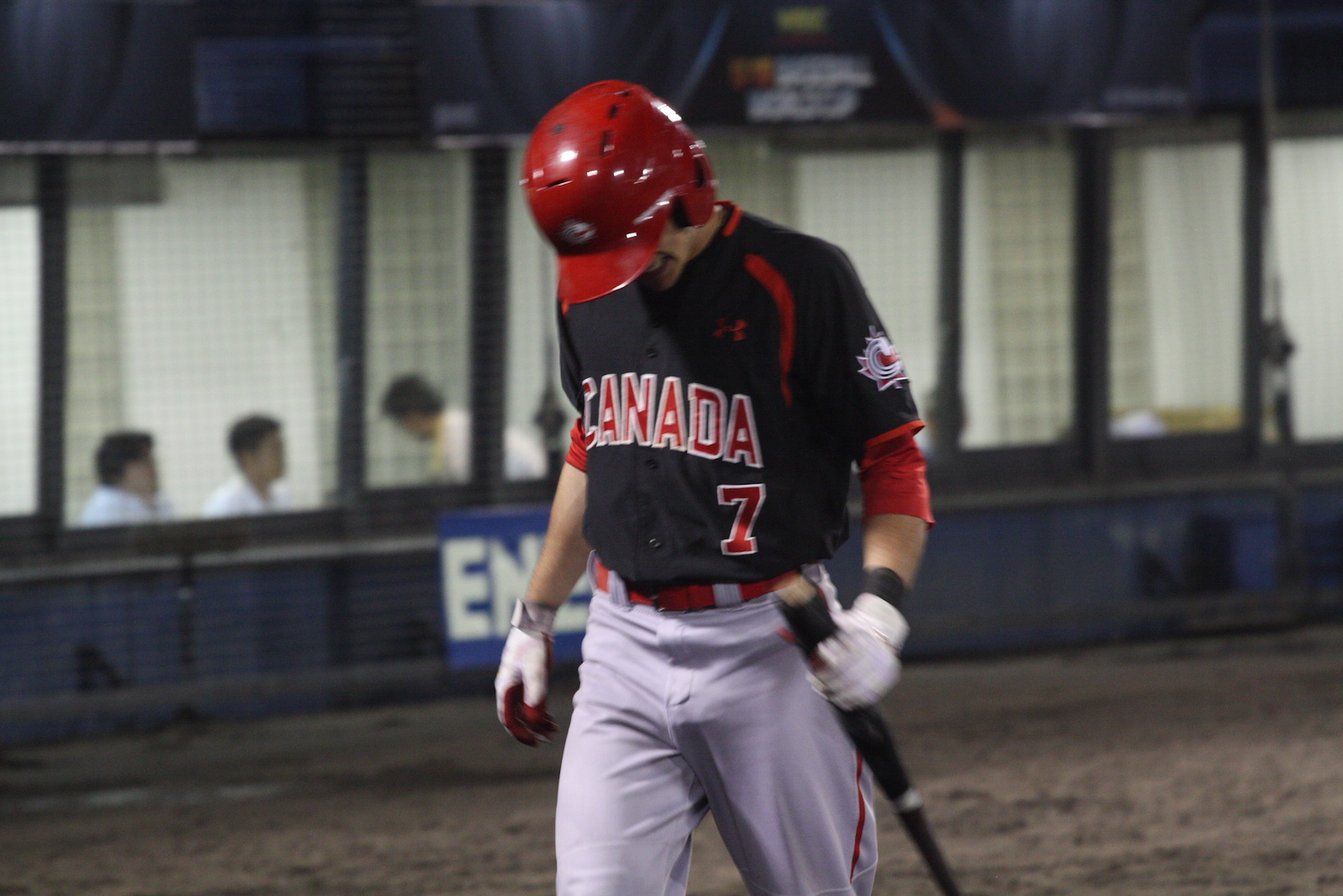 Peter Hutzal (Calgary, Alta.) returns to the dugout after an out, following same line his teammates followed in a 5-2 loss to Japan.