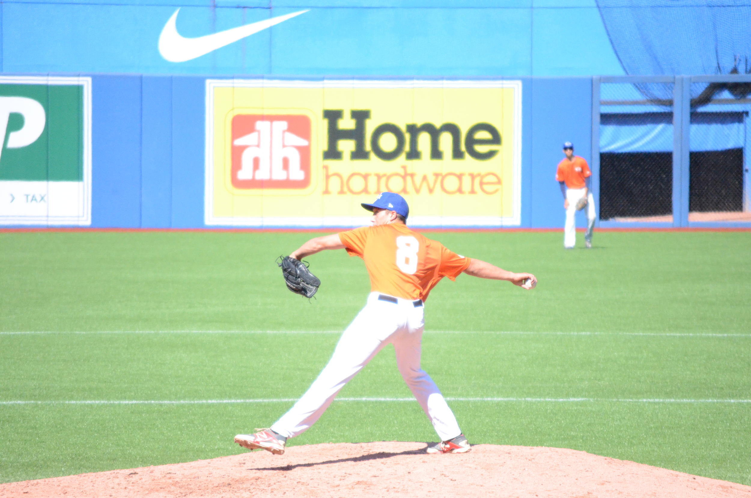 British Columbia Orange pitch Sam Shoemaker (Lions Bays, BC) of the North Shore Twins, delivers a pitch to Alberta Red. Photo: Daniel Goffenberg.