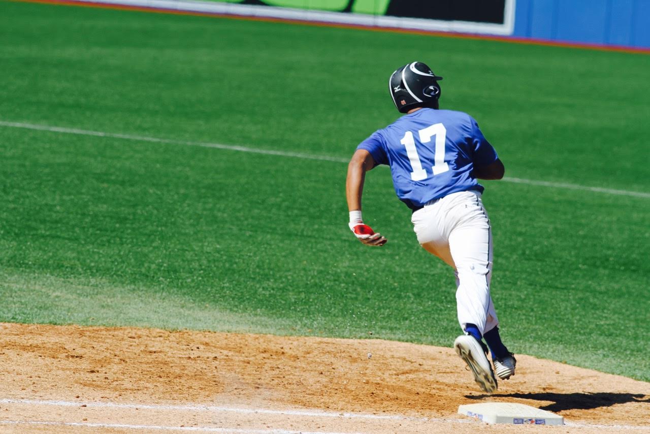 OF Isaac Deveaux barrels around first base during Tournament 12 play at the Rogers Centre. Photo: Tyler King.