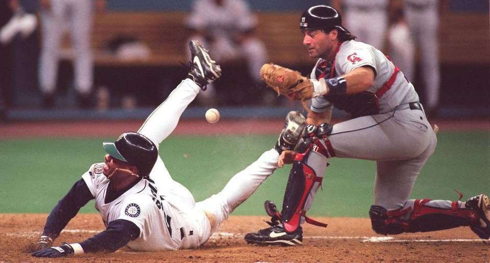 Seattle Mariners CF Ken Griffey scores dislodging the ball from California Angels C Greg Myers.