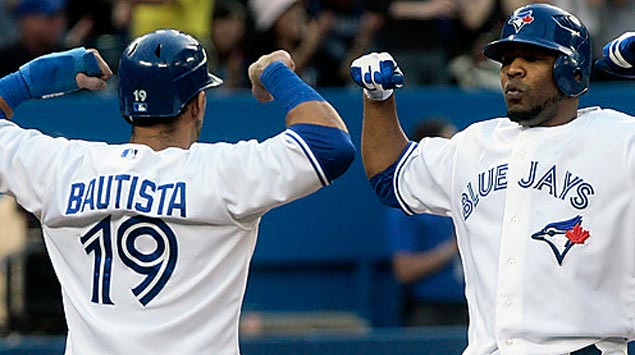 Jose Bautista (19) greets Edwin Encarnacion after another long bomb. Both are entering the final years of their contracts. 