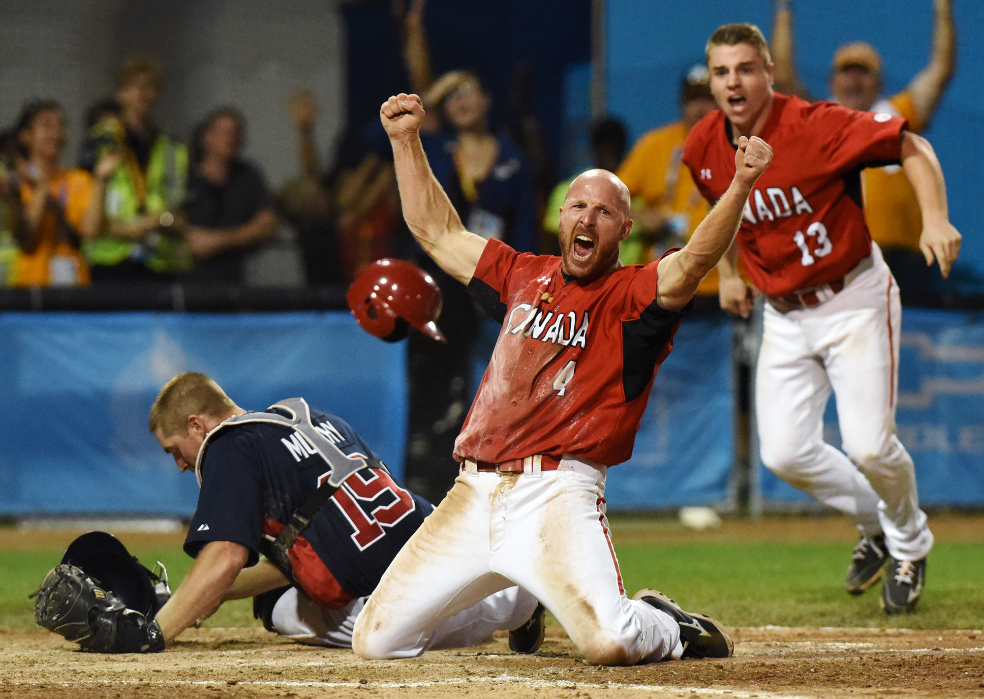 And with the head first slide Peter Orr is safe and Canada wins gold with one out in the bottom of the 10th at the Pan Am Games in Ajax. Photo: Ryan Pfeiffer/Metroland.