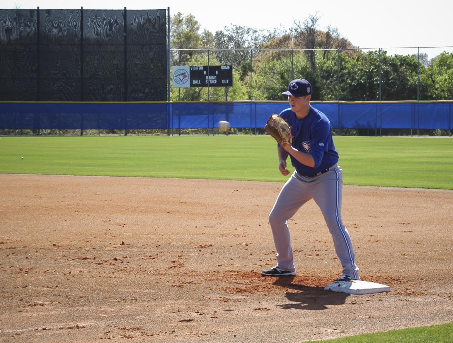 Christian Williams takes fielding practice at first base. Photo: Kyle Forster