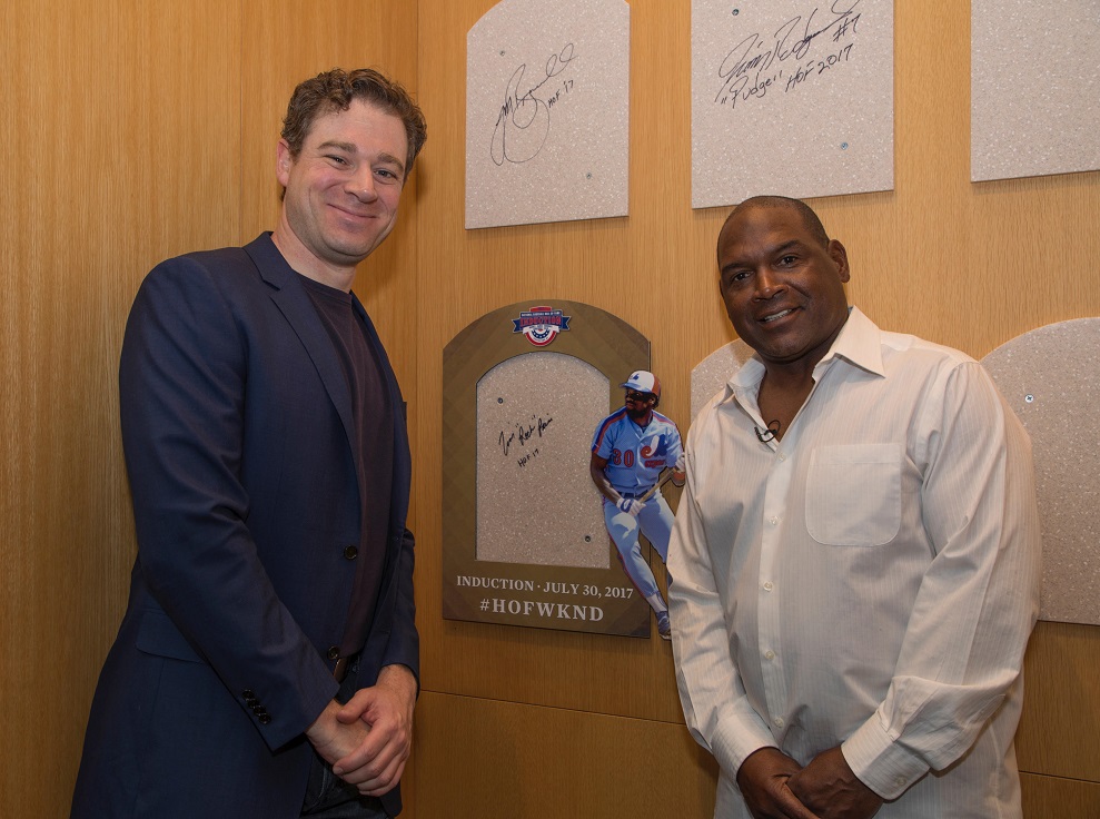 Chicago White Sox first base coach Tim Raines, left, examines a