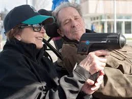 Wayne Norton checks the gun reading as he and his wife Trudy double-team a UBC game last spring. Photo: Wilson Wong.