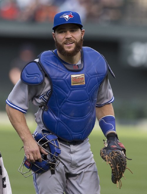 Toronto Blue Jays' Brett Lawrie keeps an eye on his hands