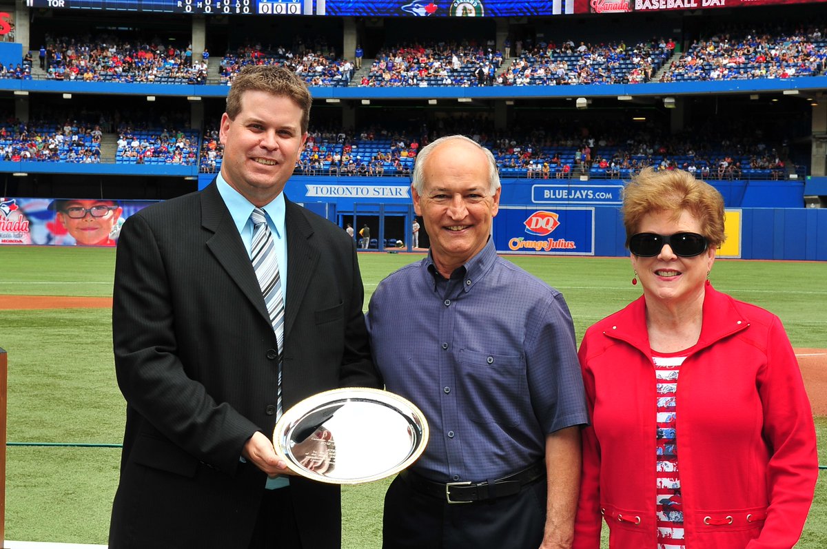 Jerry Howarth is presented with the 2012 Jack Graney Award by Canadian Baseball Hall of Fame director of operations Scott Crawford at Rogers Centre. Howarth's wife Mary was also on hand for the presentation. Photo Credit: Canadian Baseball Hall of Fame