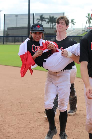 Eric Rutherford carries Keiran Martini-Wong off the field. Photo: Saskia Martini-Wong Studios.