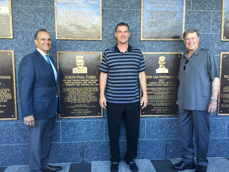 Former Toronto Blue Jays pitcher Todd Stottlemyre (middle) had the opportunity to visit Monument Park at Yankee Stadium with his dad, Mel, (right) and Joe Torre (left). Mel Stottlemyre’s plaque can be seen between Stottlemyre and his dad. Photo Credit: Todd Stottlemyre
