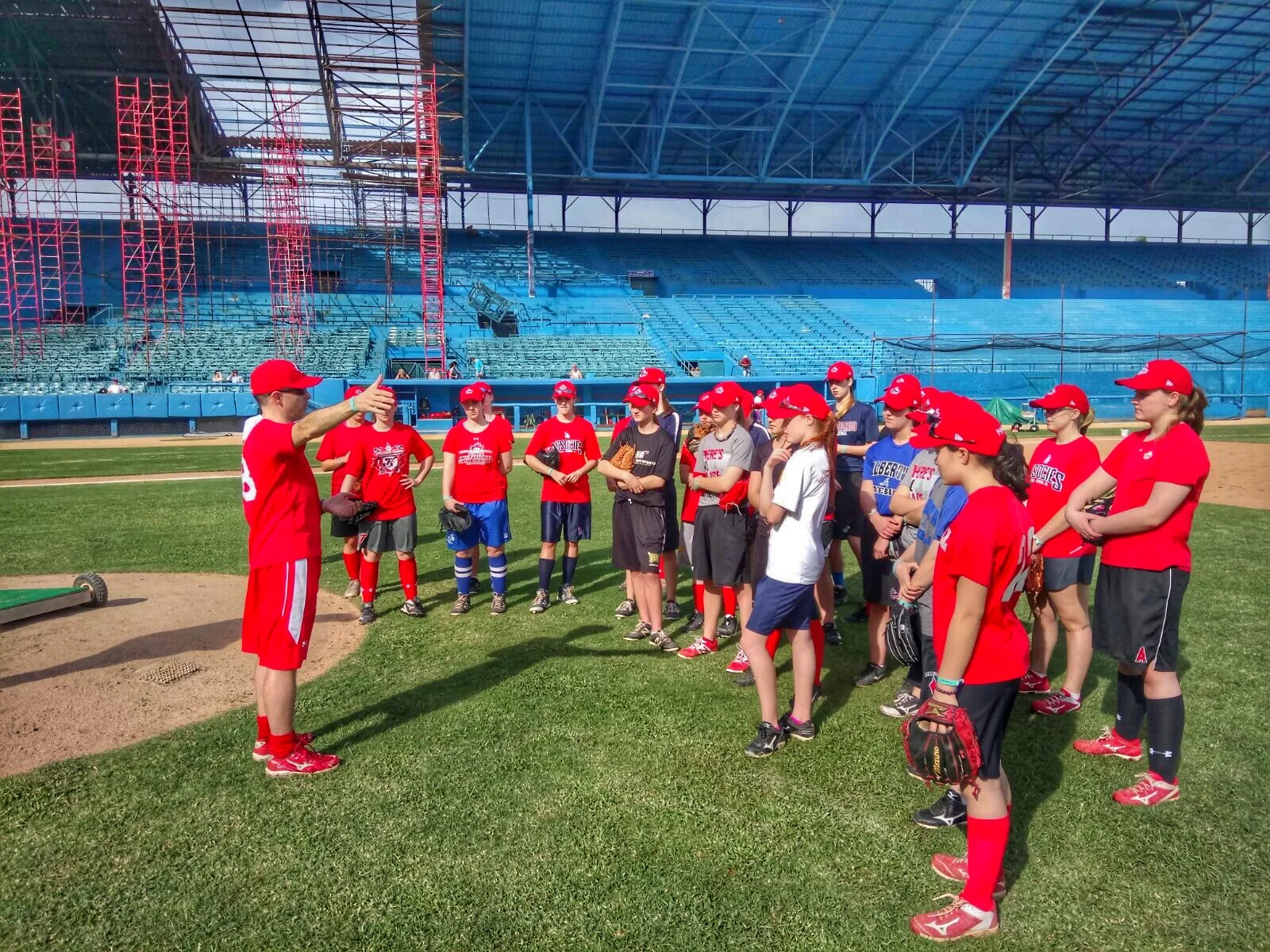 Andre Lachance (far left) talks to young Canadian players attending the national women's team development camp in Cuba