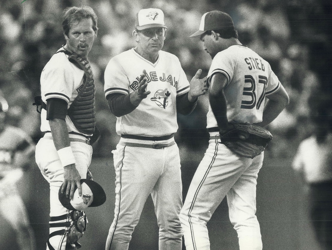 Blue Jays manager Bobby Cox talks to RHP Dave Stieb (37) and C Ernie Whitt.