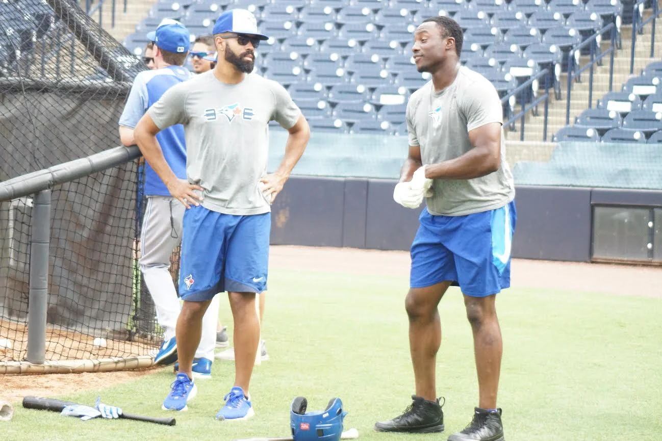 Oakville Royals’ grad OF Dalton Pompey (Mississauga, Ont.), left, begins his rehab assignment Monday with the class-A Dunedin Blue Jays. and during batting practice chats with former Ottawa-Nepean Canadians OF Demi Orimoloye (Ottawa, Ont.) in Tampa. Photo: Eddie Michels.