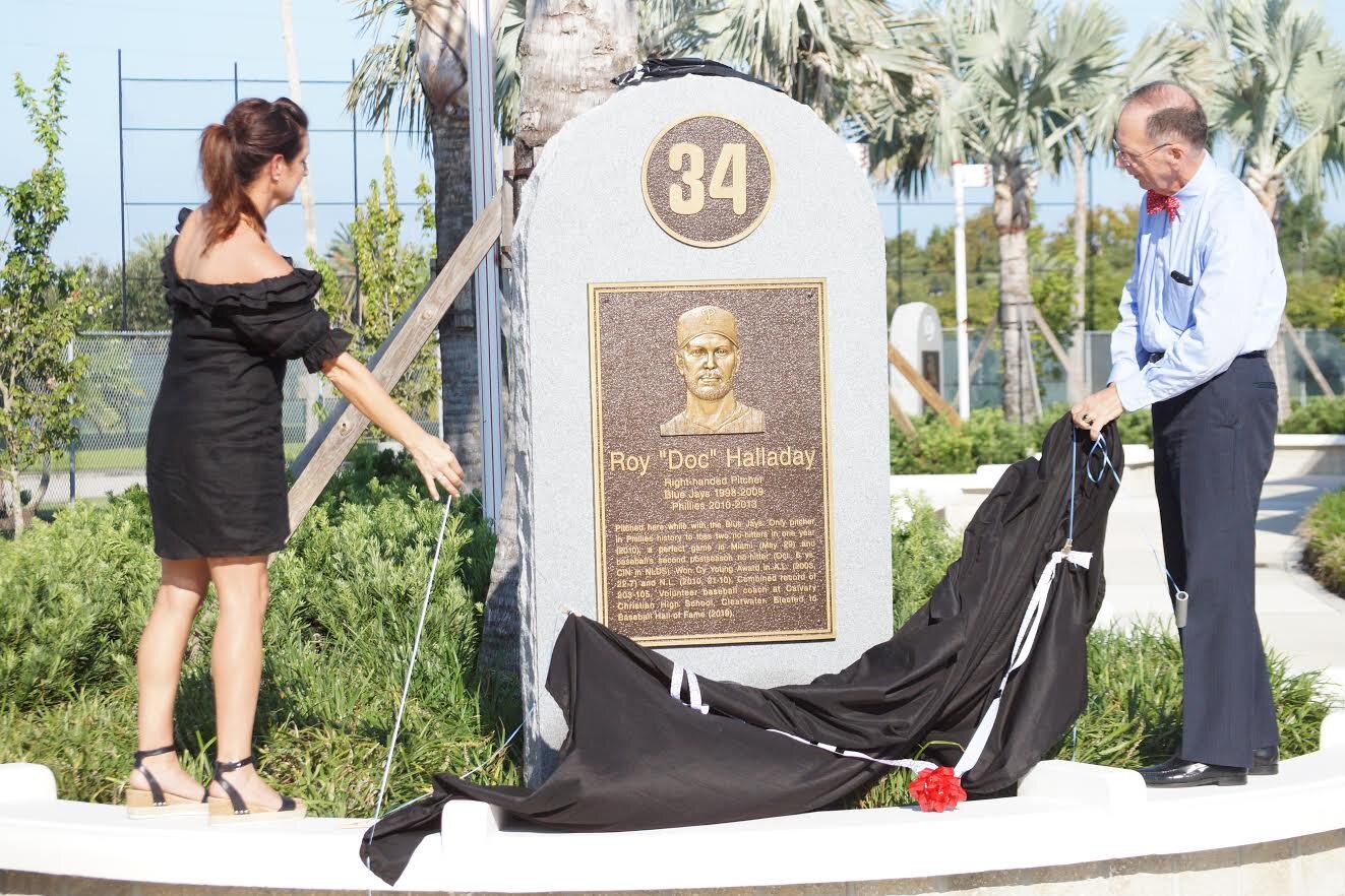 Brandy Halladay, left, and Clearwater Mayor George Cretekos unveil the memorial monument to Brandy’s late husband Roy Halladay at Jack Russell Memorial Stadium in Clearwater, Fla. Photos; Eddie Michels.