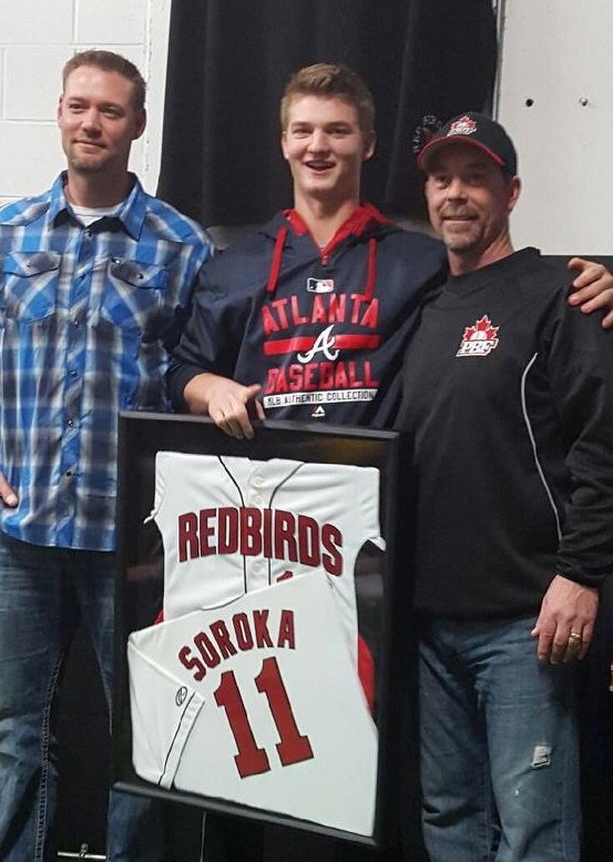 Former major leaguer Chris Reitsma (Calgary, Alta.), left, Sunday’s hero RHP Mike Soroka (Calgary, Alta.) and Calgary PBF Redbirds. coach Jim Lawson. Photo: Lawson family, Alberta Dugout Stories.