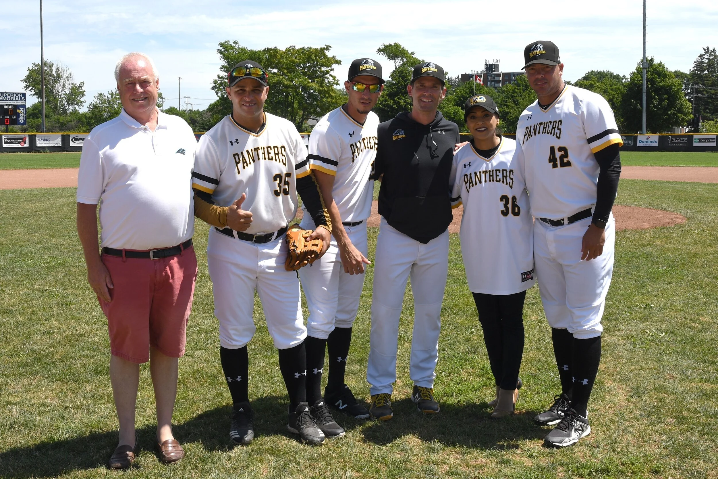 Kitchener Panthers GM Mike Boehmer, left, poses with Kitchener MP Bardish Chagger, second from right, along with Panthers manager Luke Baker and Cuban players Yorbis Borroto (35), Yuen Soccaras in middle, and Miguel Lahera (42). Missing is Yoennis Yera. Photo by Dan Congdon