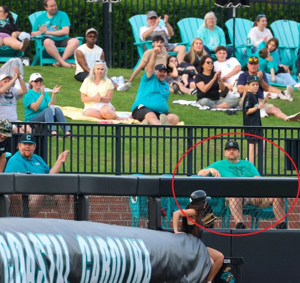 John Reed makes a one-handed claw grab watching his Coastal Carolina Chants