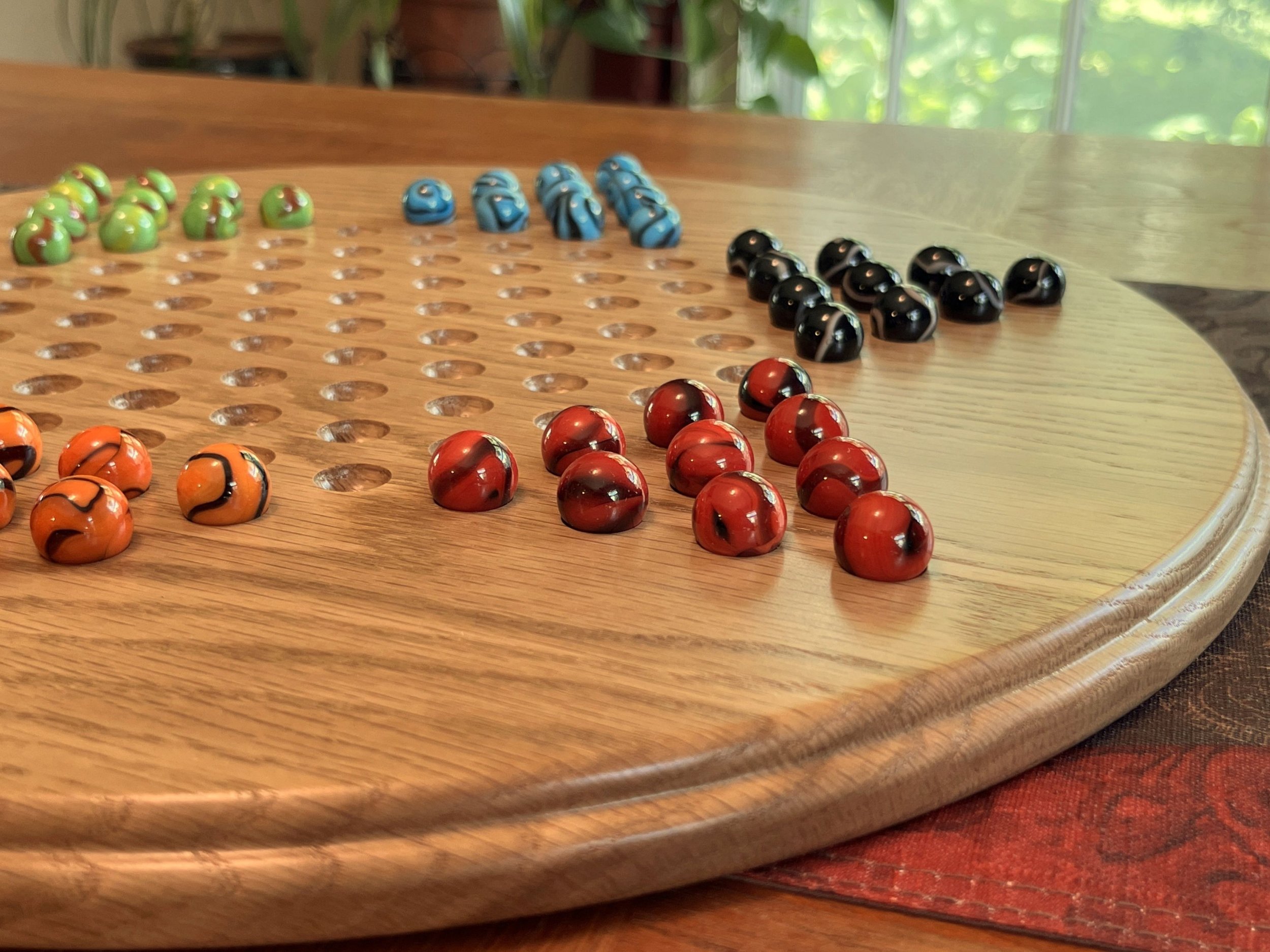 Solid oak Chinese checkers board; image shows the side profile