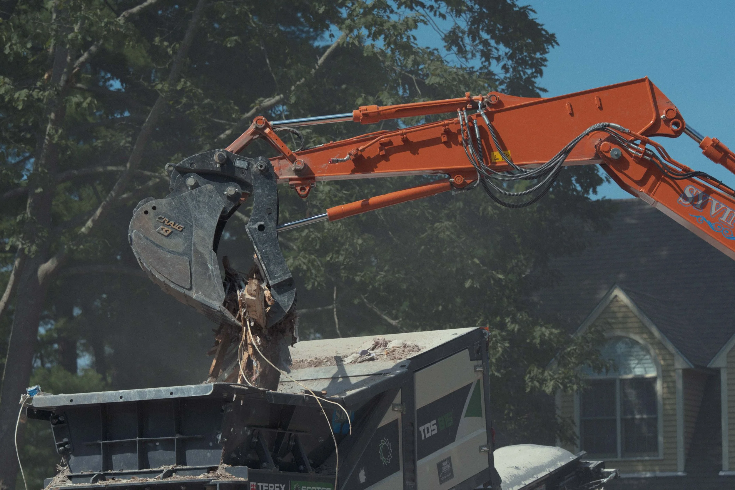 excavator bucket moving debris
