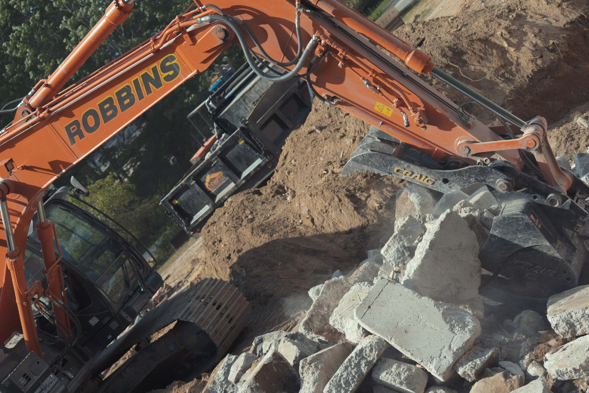 excavator bucket moving large rocks