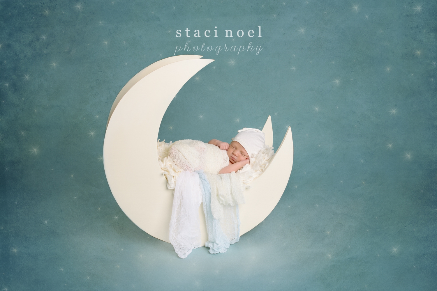 Charlotte newborn photographer Staci Noel photographys newborn baby boy in moon prop on night sky backdrop