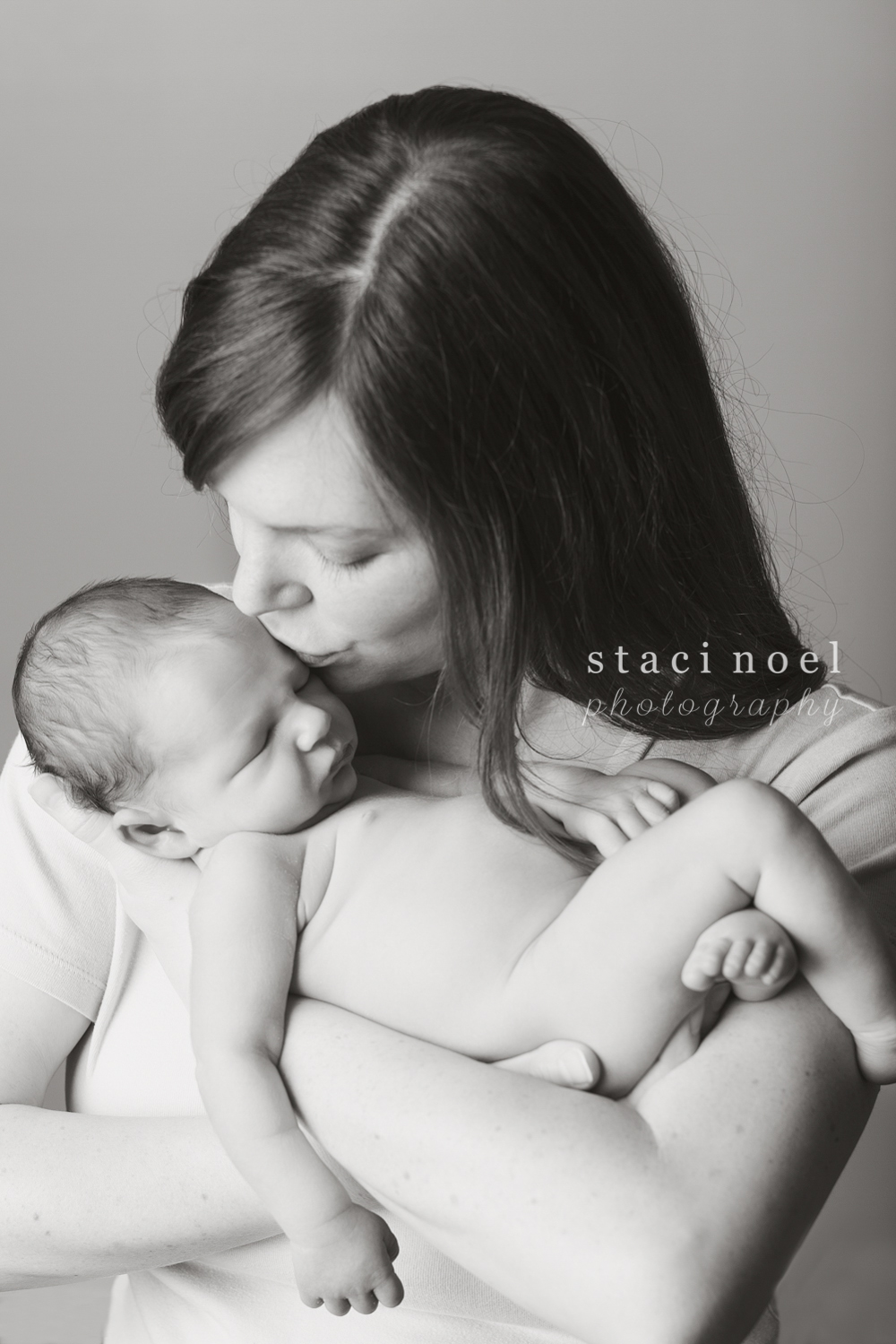 Charlotte NC newborn baby boy photographed by Staci Noel Photography in his mothers arms