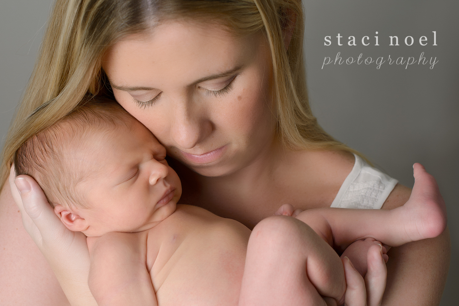 Charlotte NC newborn baby boy photographed in his mother's arms by Staci Noel Photography