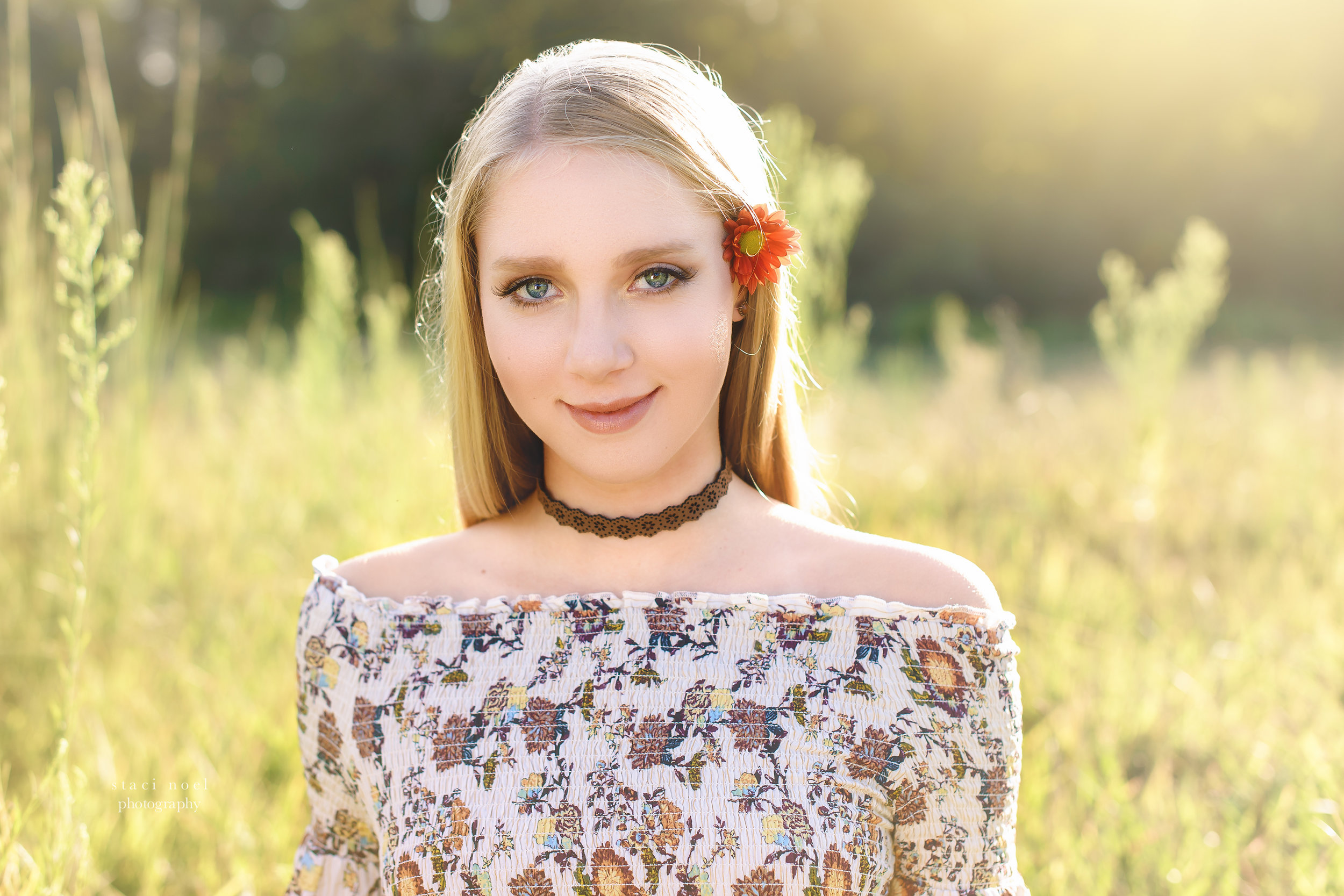  staci noel photography portraits of high school senior girl in dress in a summer field in Harrisburg NC on a red sofa 