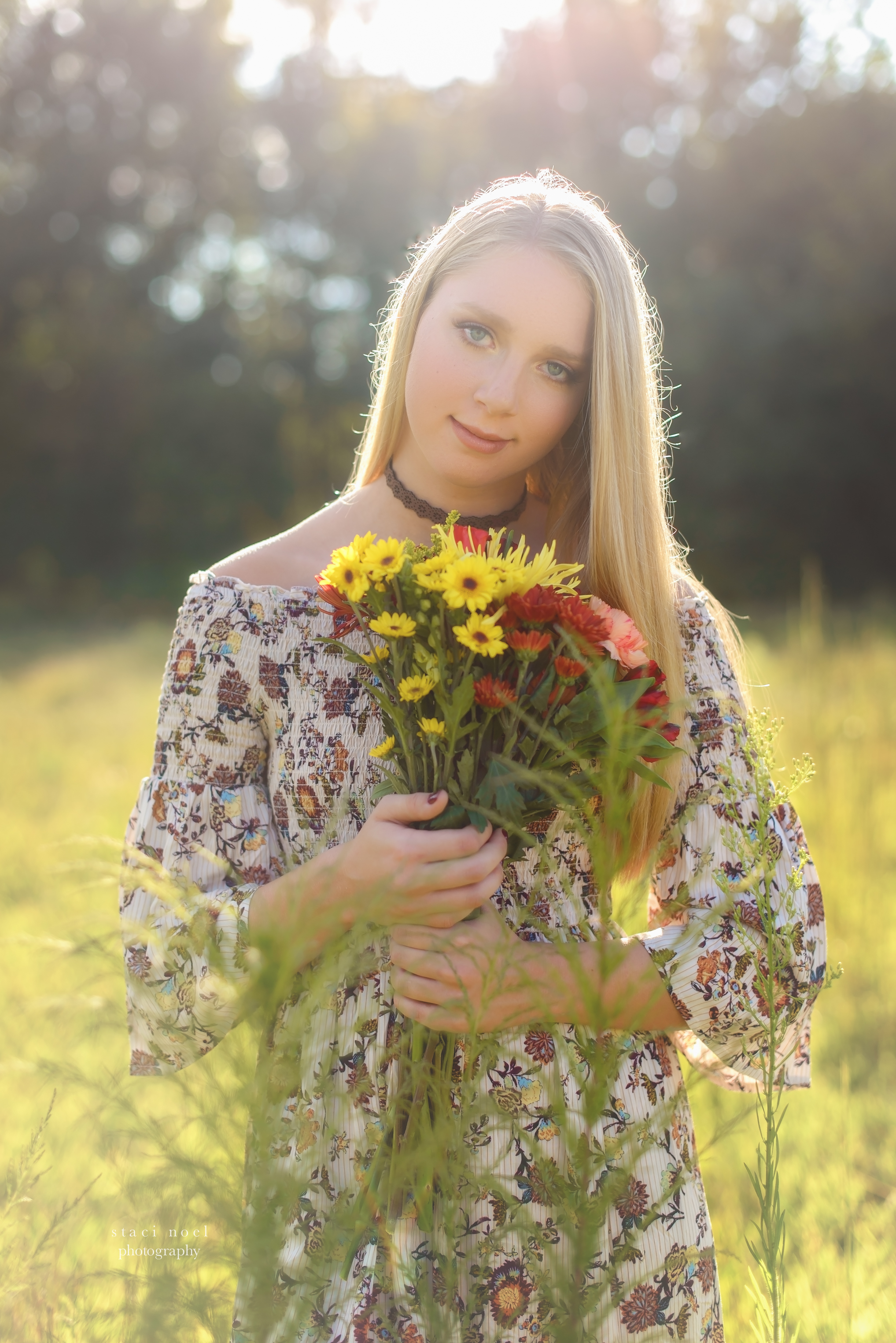  staci noel photography portraits of high school senior girl in dress in a summer field in Harrisburg NC on a red sofa 