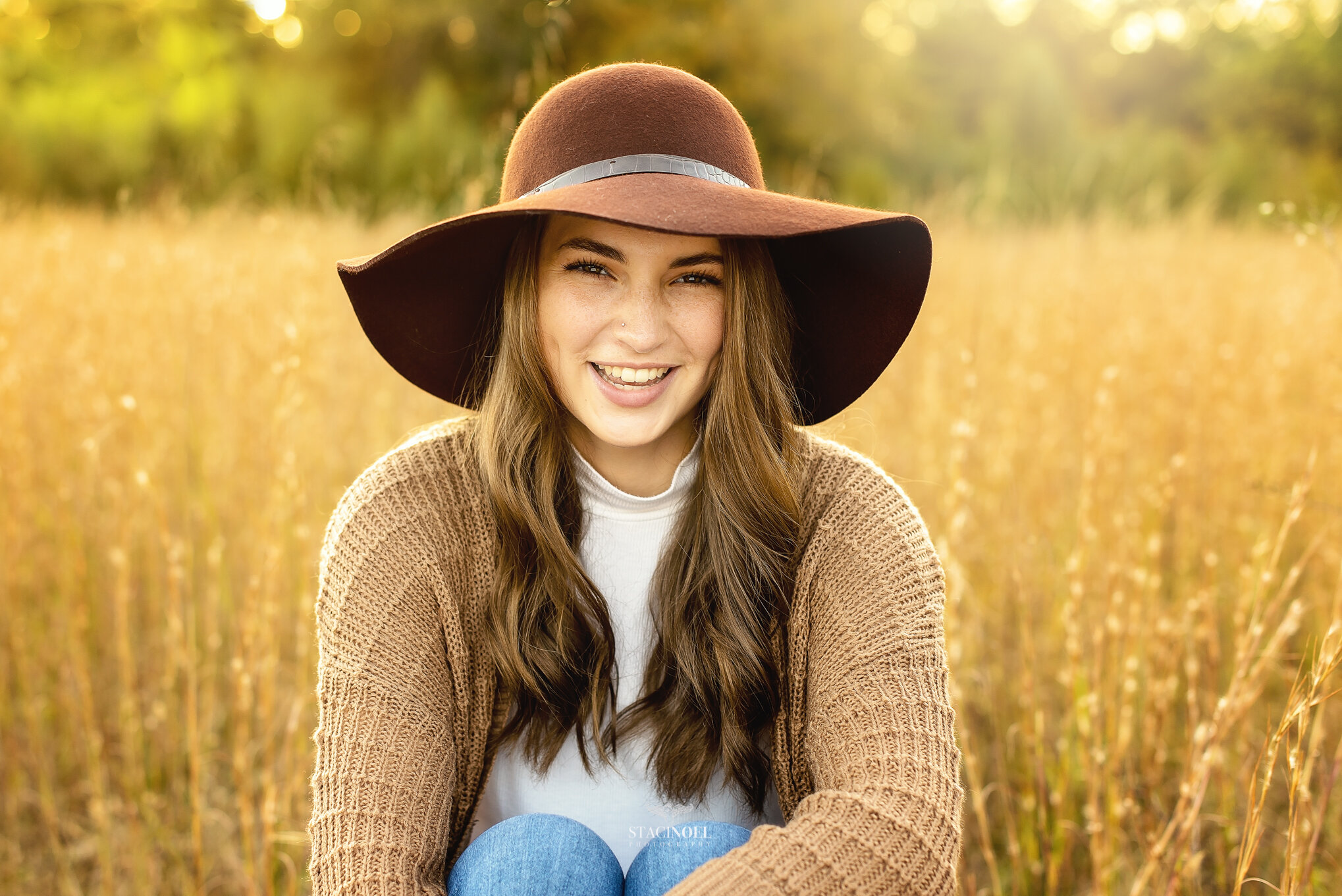  Staci noel photography photographs hickory ridge senior girl for senior portraits outside in natural light in field with tall grass and sunset 