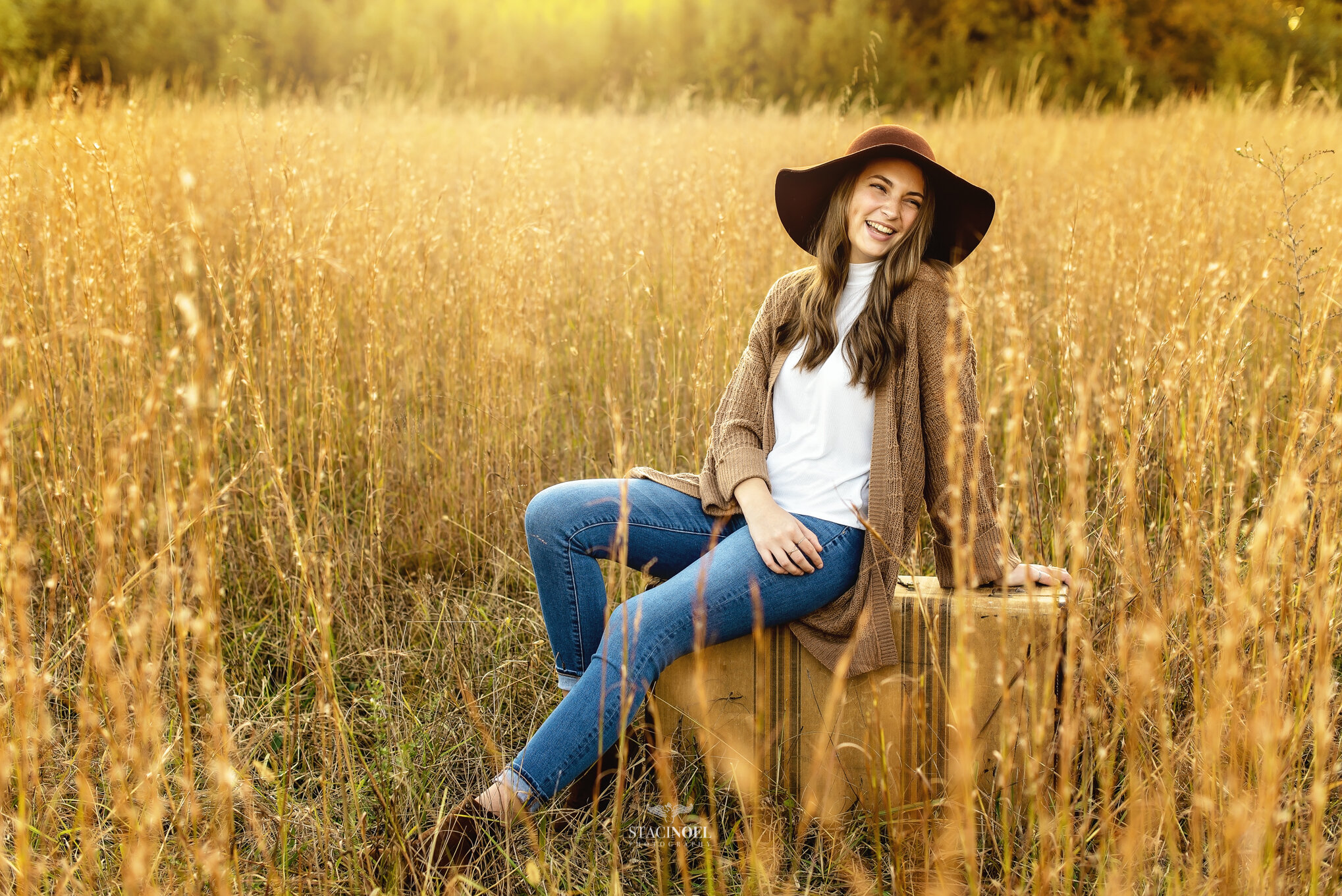  Staci noel photography photographs hickory ridge senior girl for senior portraits outside in natural light in field with tall grass and sunset 