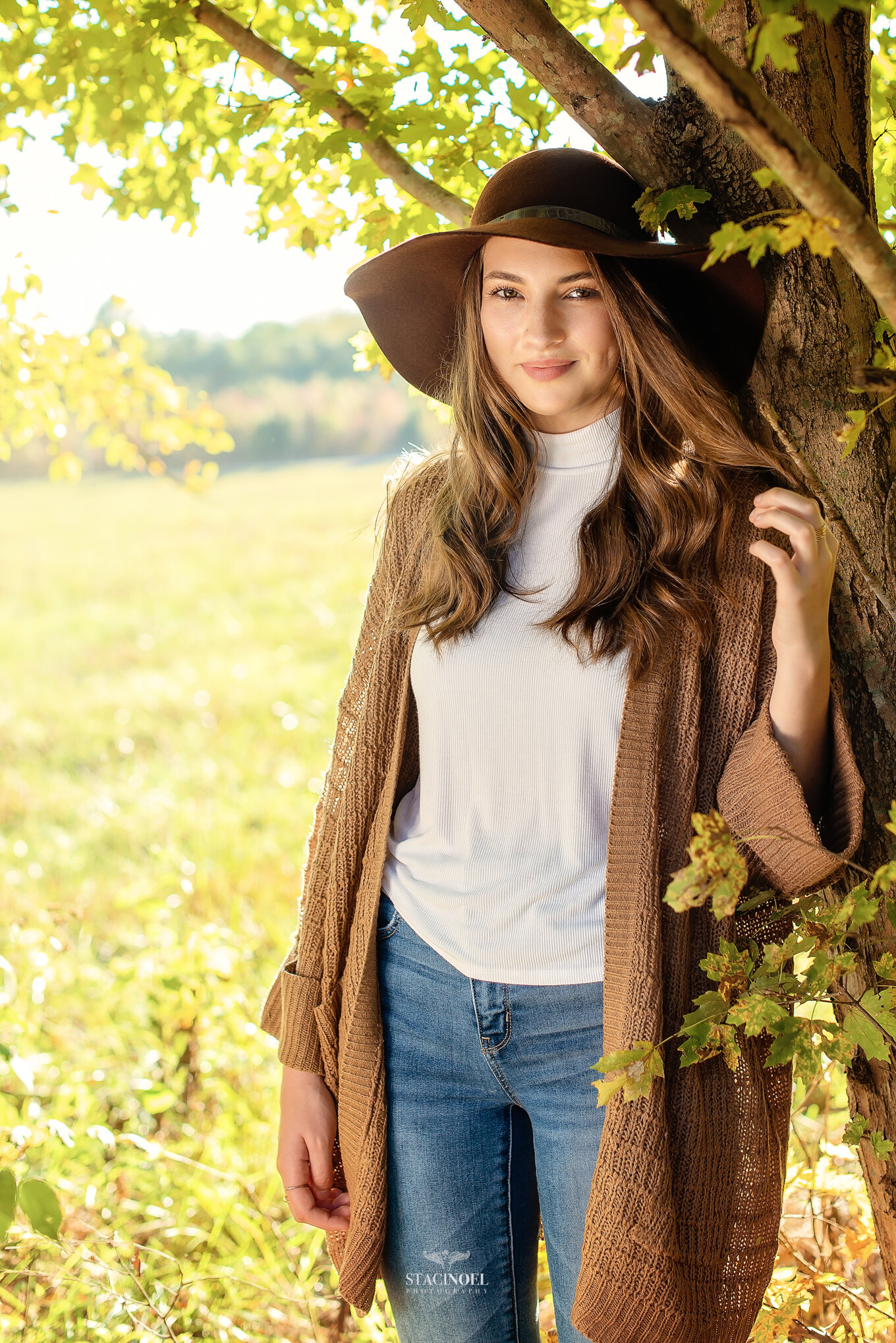  Staci noel photography photographs hickory ridge senior girl for senior portraits outside in natural light in field with tall grass and sunset 