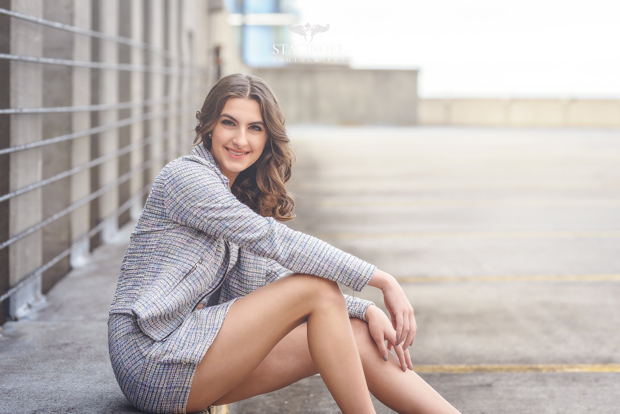 Long Legs Fashion Blonde Girl Sitting on Bench. Street Fashion. Stock Photo