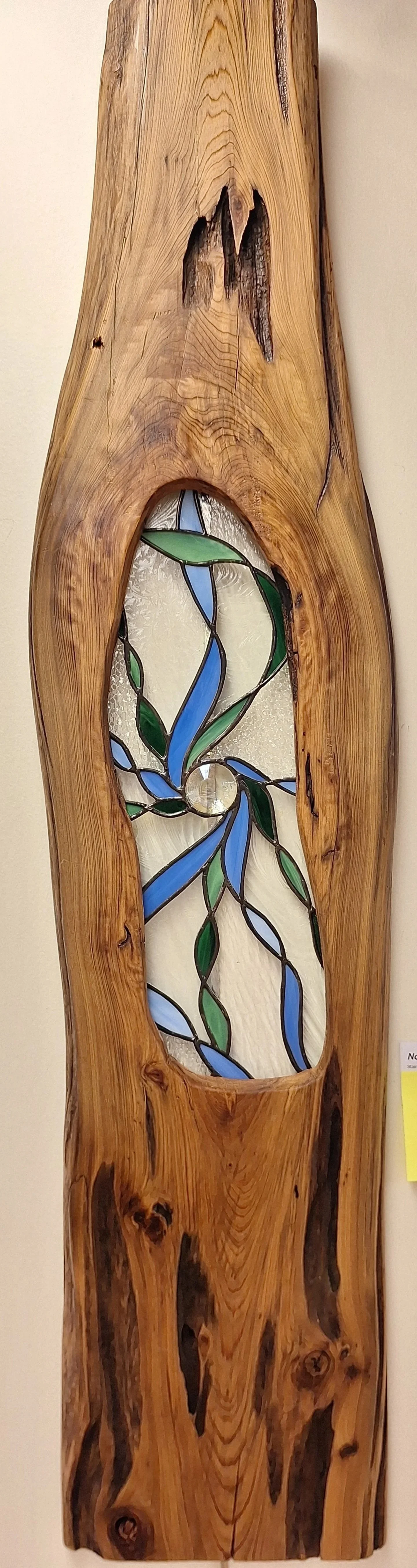 Transparent and Blue Stained glass artwork in Wooden Frame, hung on white wall background