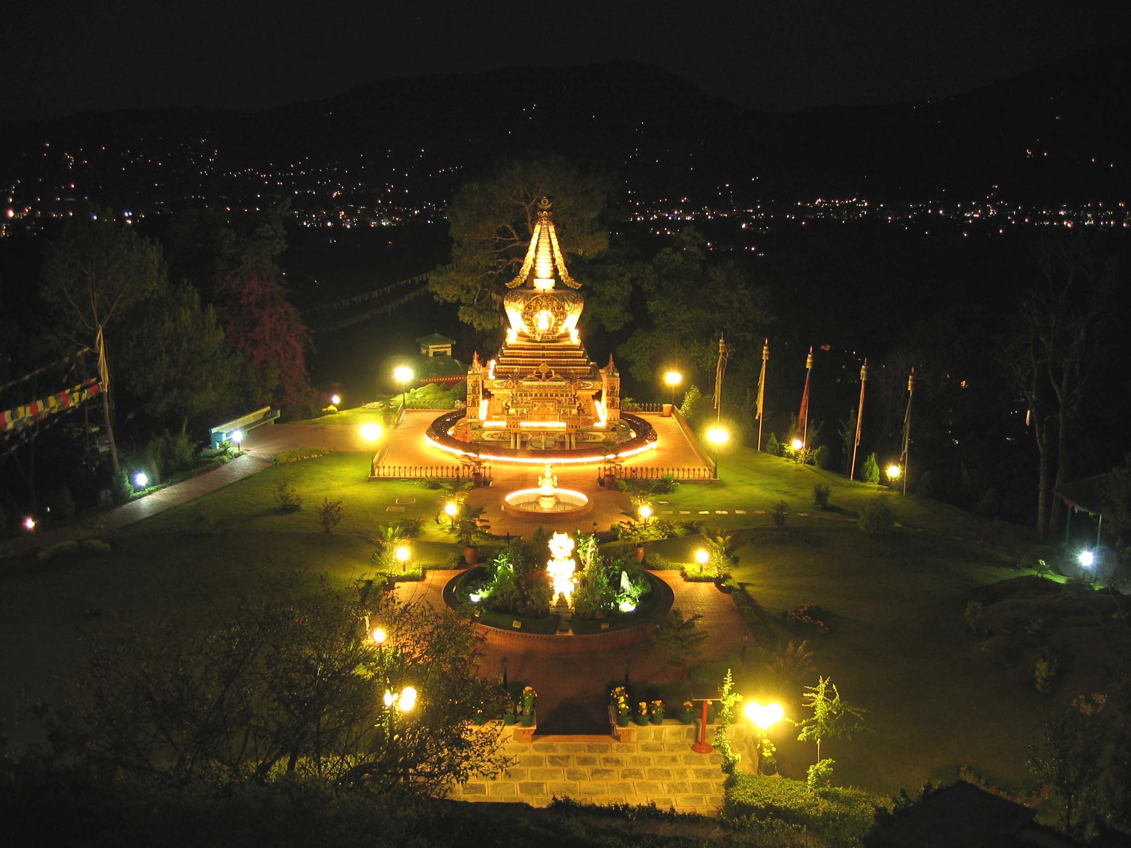 Solar illuminated stupa and gardens at night