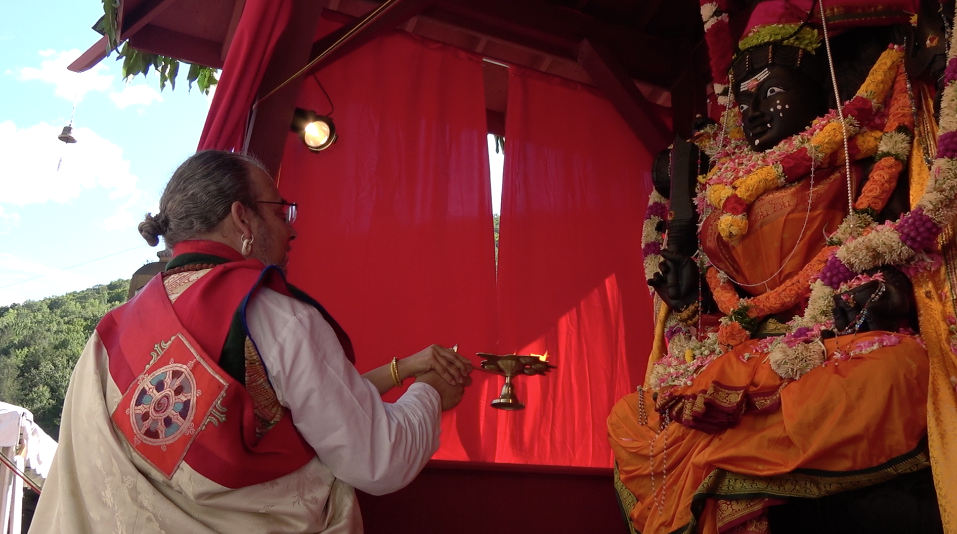 Lama Offering lights for World Peace.png