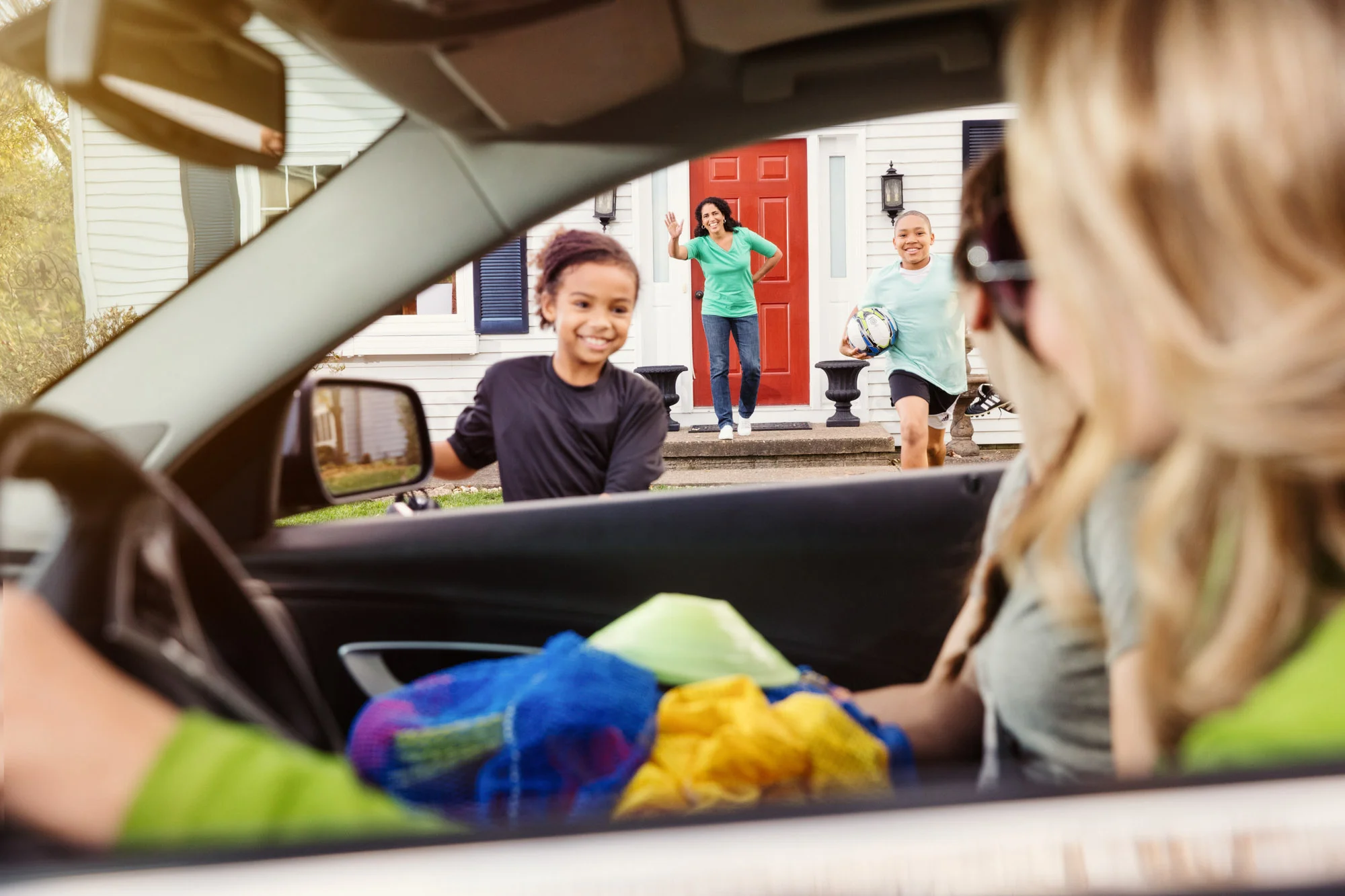 Kids running up to greet car in Two Rivers Bank & Trust advertisement.