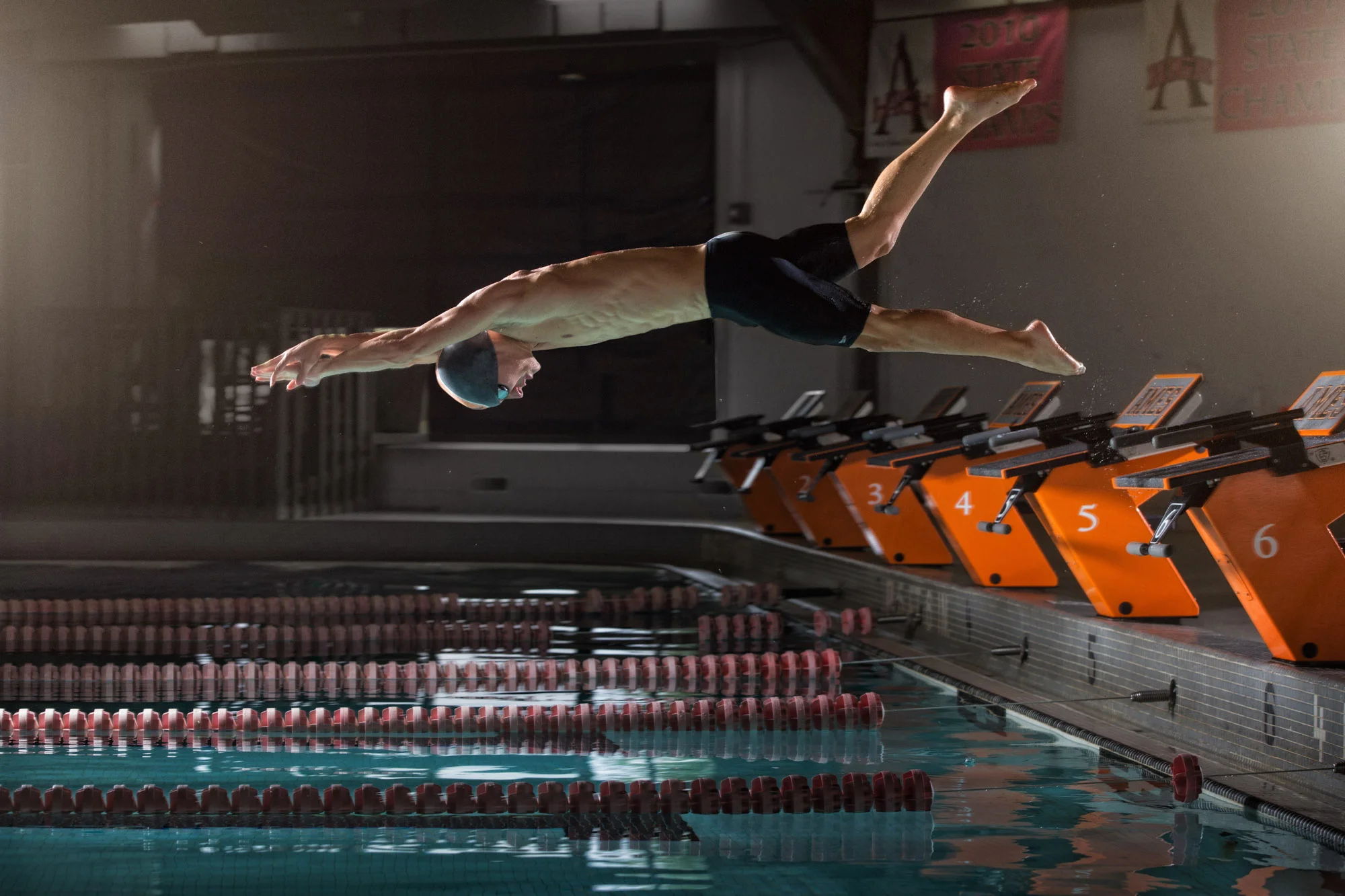 High school senior boy diving into pool