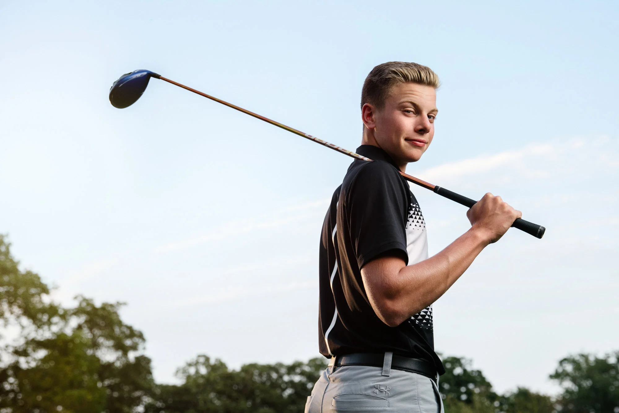 Golfer senior portrait outdoors with driver