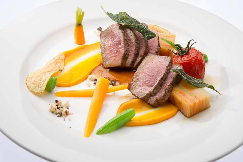 Seared lamb loin with sweet potato gratin, slow roasted cherry tomato's, cinnamon sweet potato pure, crisp sage and cacao crumble