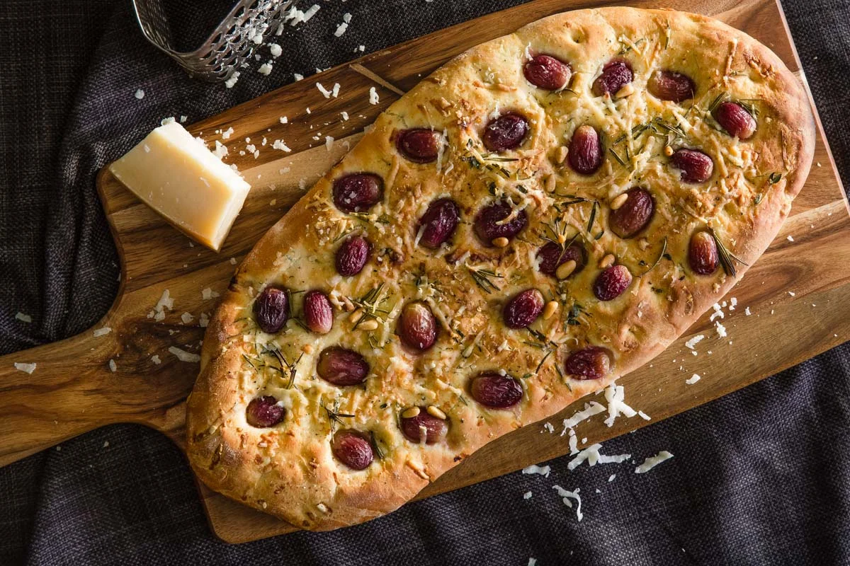 Turkish style bread with grapes, Parmesan cheese, rosemary and pinenuts