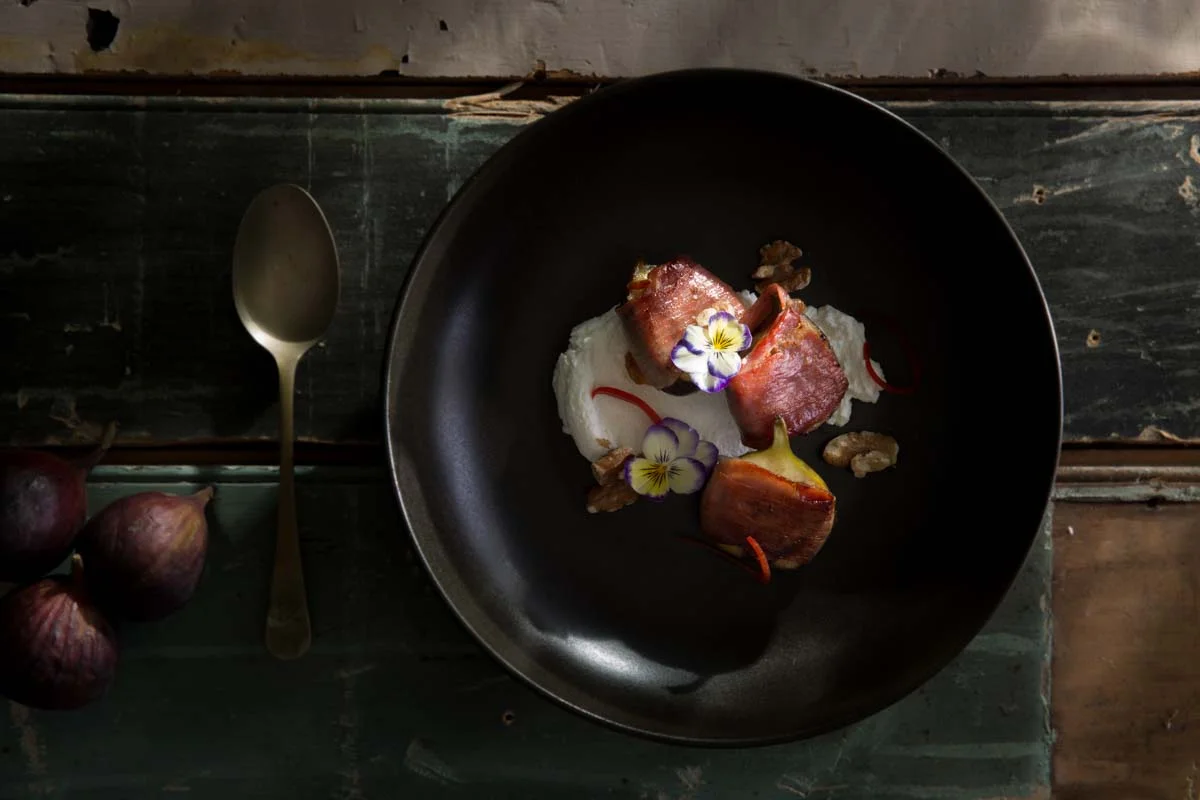 Grilled prosciutto rapped figs with goats curd, walnuts and julienne red pepper