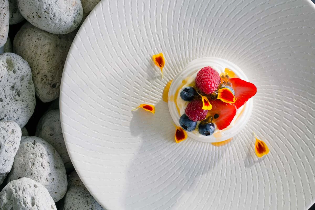 Pavlova with maple syrup cream, fresh berries and passion fruit syrup