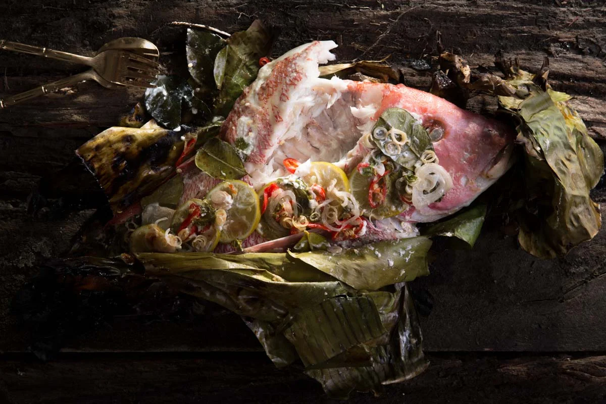Barbeque Red Emperor wrapped in banana leaf with Thai green curry sauce