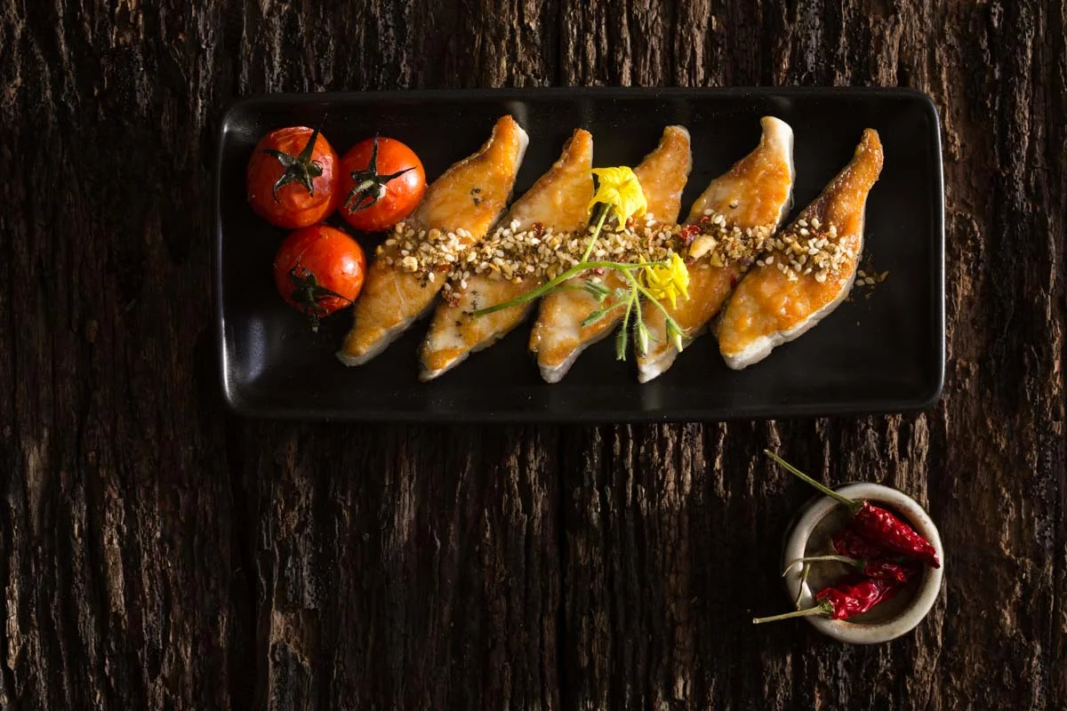 Grilled kingfish with sweat miso paint, roast cherry tomato's and hazelnut dukkah